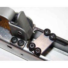 Trigger guard screw plate in the white, with four black screws installed in receiver.