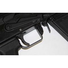 Close-up of Saiga 12 trigger guard and selector stop, black finish, installed on receiver.