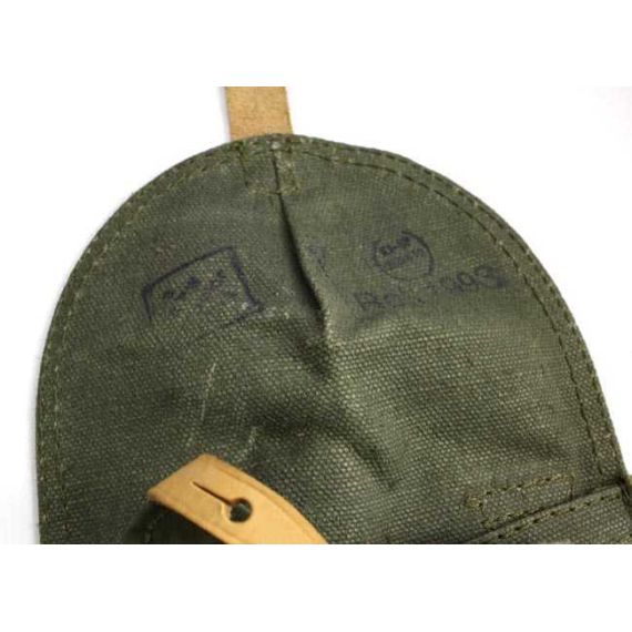 Close-up of textured olive drab canvas flap on Polish AKM magazine pouch, showing leather strap.