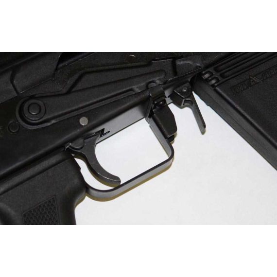 Close-up of Saiga 12 trigger guard and selector stop, black finish, installed on receiver.