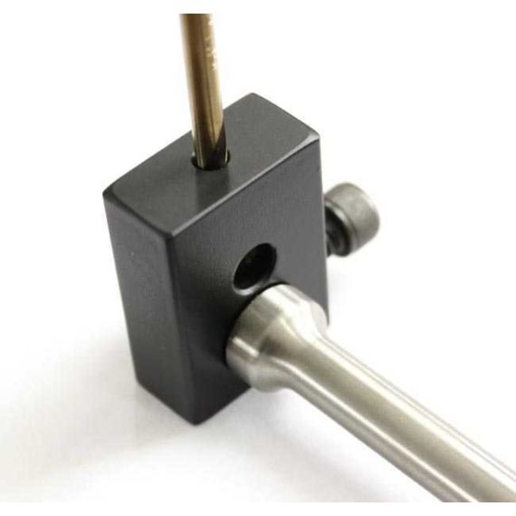 Close-up of AK-Builder black heat-treated steel gas piston drilling jig holding piston and TiN coated drill bit.