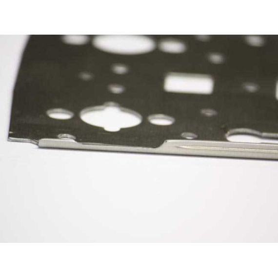 Angled close-up of AK-Builder Polish Underfolder receiver flat, 1mm 4130 annealed steel in the white.