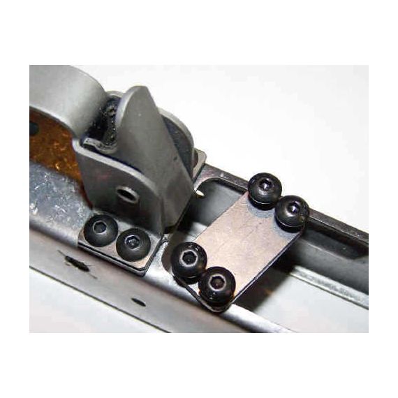 Trigger guard screw plate in the white, with four black screws installed in receiver.