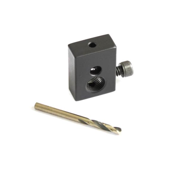 Angled view of dark heat-treated steel gas piston drilling jig, TiN drill bit.