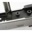 AK-Builder black oxide steel rail alignment fixture installed in unfinished stamped AK receiver, with leveling tool.