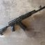 AKM rifle side view with matte black anodized TDi AK dust cover and Picatinny rail.